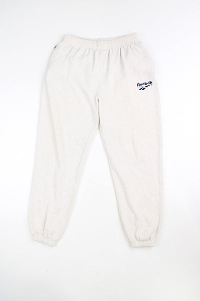 Vintage Reebok cream tracksuit bottoms/ sweat pants with elasticated waistband and cuffs and embroidered logo on the leg. good condition Size in Label: 30" - Measure like a Womens L
