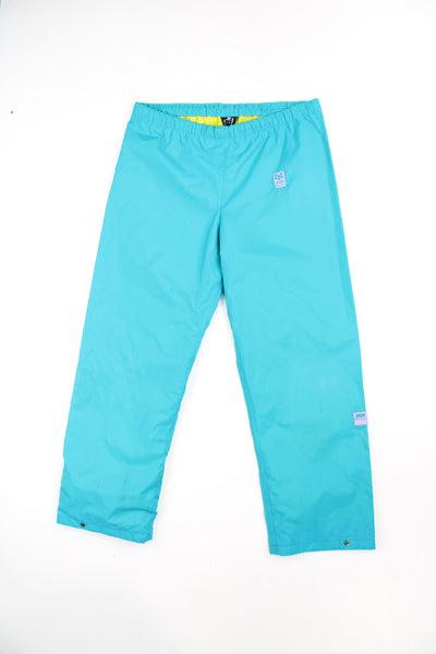Vintage Helly Tech bright blue tech trousers by Helly Hansen, features drawstring waist and embroidered logo on the hip 