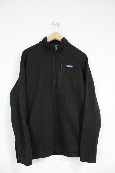 Patagonia black knit style 1/4 zip fleece with zip up chest pocket and embroidered logo on the chest