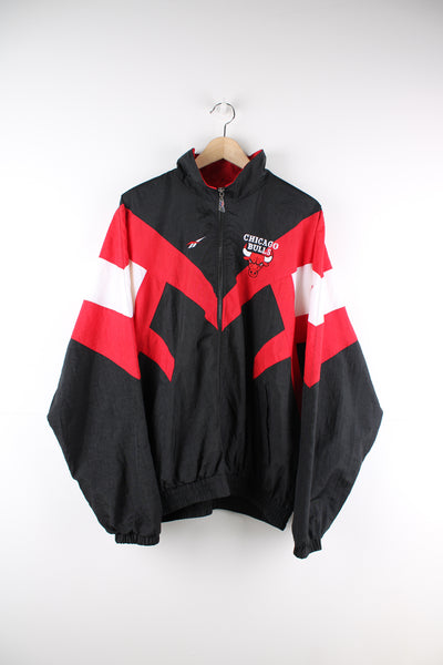 Chicago Bulls red and black lightweight pro sports jacket by Reebok. Features full zip to close and embroidered logos on the chest and back. 
