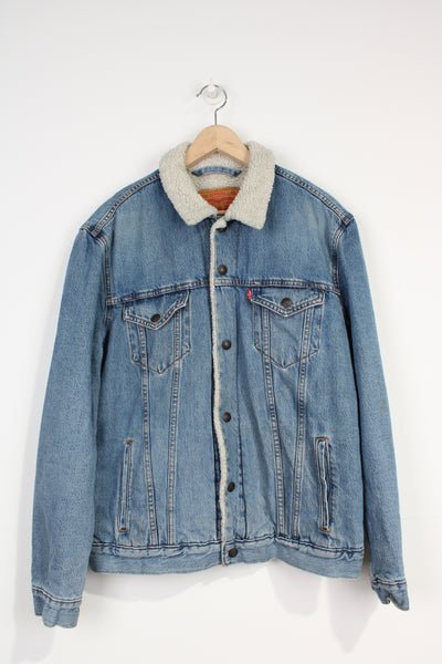 Vintage Levi Strauss light blue denim trucker jacket with popper buttons to close, sherpa lining and red tab