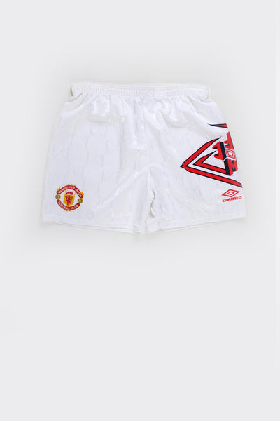 Vintage Made in England 1992-94 Manchester United home football shorts by Umbro, all white featuring raised badge on the leg and red Umbro graphic/logo on the other.