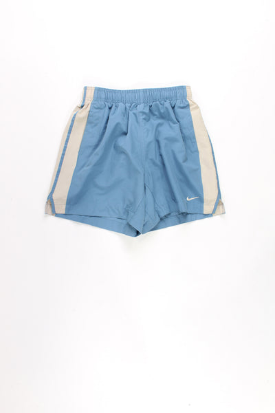 00's Nike blue and tan sports shorts featuring an elasticated waistband, inter webbing  ,drawstring waist and swoosh logo on the leg.