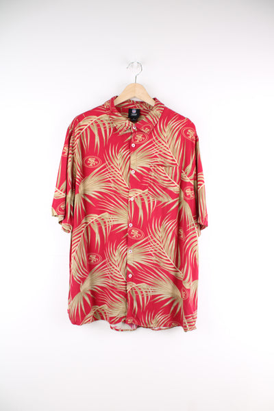 San Francisco 49ers Hawaiian Shirt in a red and gold colourway, floral design with the team logo printed all over, button up and has a chest pocket.