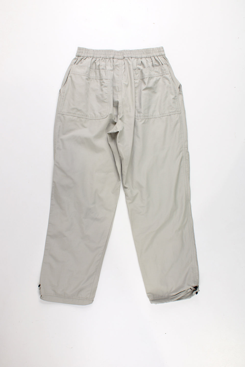 Adidas Tracksuit Bottoms in a tan colourway, has a elasticated waist, velcro fly, multiple pockets, and logo embroidered on the front.