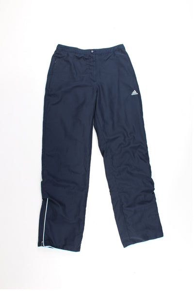 Adidas Tracksuit Bottoms in a dark blue colourway, has a elasticated waist, pockets, and logo embroidered on the front.