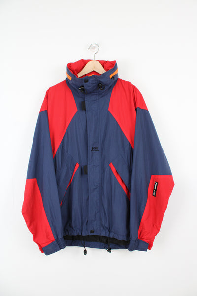 Vintage blue and red Helly Hansen waterproof jacket with embroidered logo on the front and foldaway hood