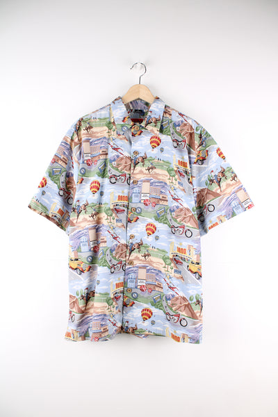 Vintage Dem Crazy Hawaiian Shirt in a blue colourway with gambling and rodeo style design printed all over, button up and has a chest pocket.