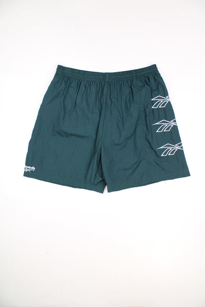 Reebok Shorts in a green colourway, no pockets, netted lining, and has the logo embroidered down the left side and on the front.
