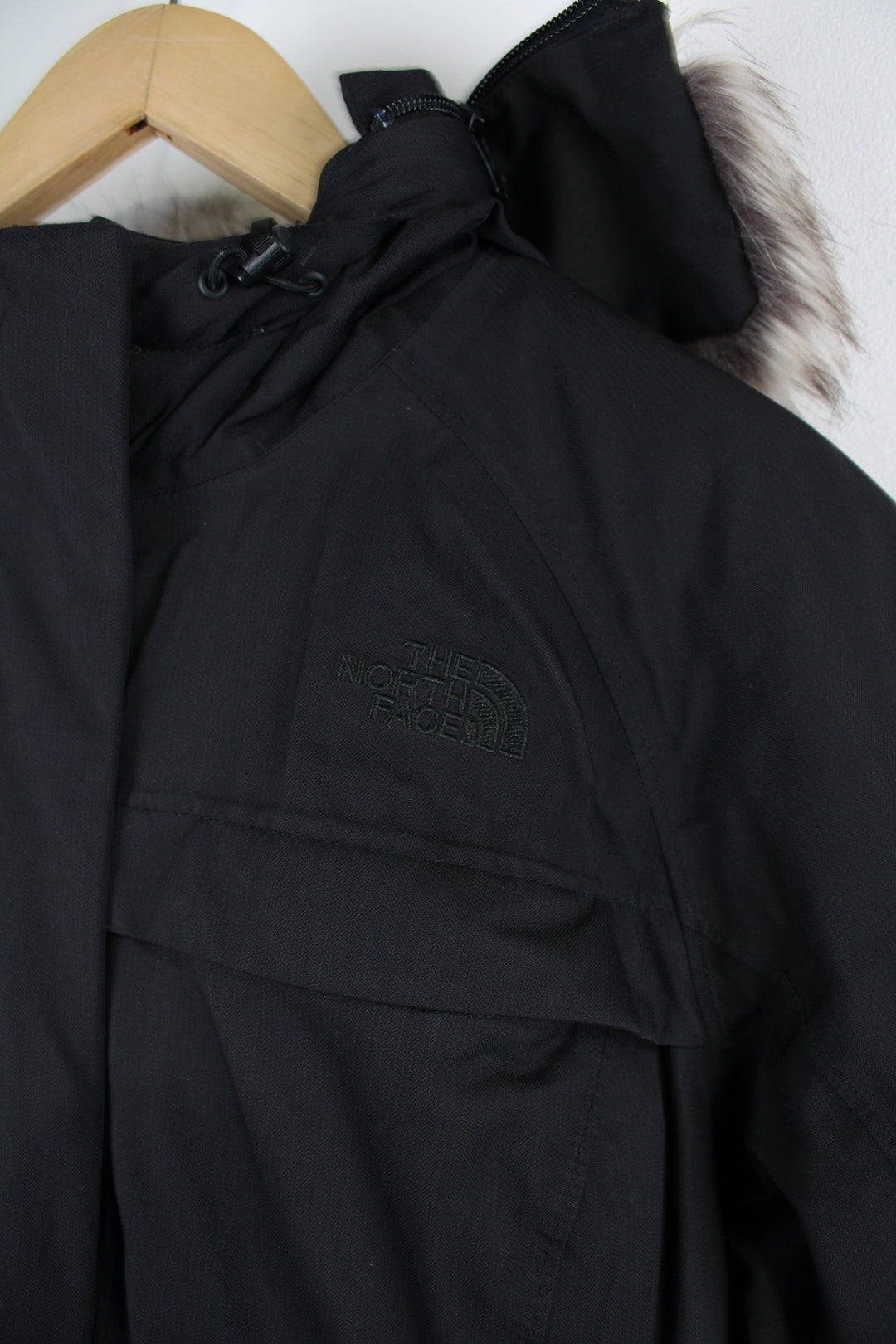 The North Face Parka Jacket in a black colourway, insulated with a quilted lining, zip up, multiple pockets, hooded with detachable fur option, and has logo embroidered on the front. 
