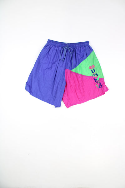 Umbro Shorts in a blue, purple and green colourway, adjustable waist, pockets, and has the spell out logo going down the left side.