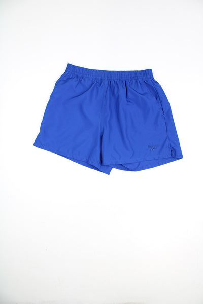 Reebok Shorts in a blue colourway, adjustable waist, pockets, and has the logo embroidered on the front.