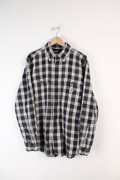 Navy blue plaid Carhartt loose fit, button up cotton shirt, has embroidered logo on chest pocket
