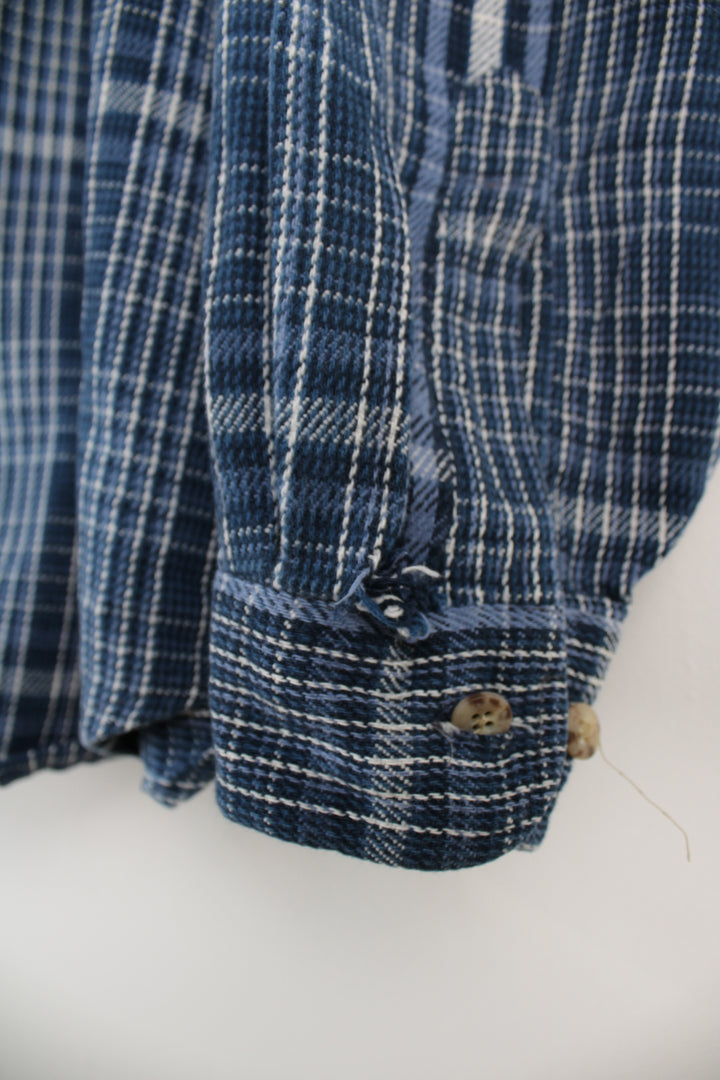 Navy blue plaid Carhartt button up shirt, has small embroidered logo on chest pocket