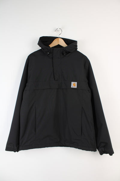 Black Carhartt pull over 1/4 zip jacket with fleece lining and embroidered logo on the chest