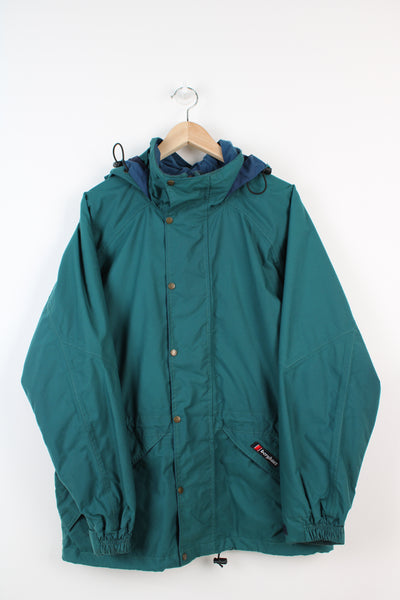 Vintage Berghaus 'Palisade I.A' green outdoor jacket with embroidered logo on the pocket, drawstring waist and hood.