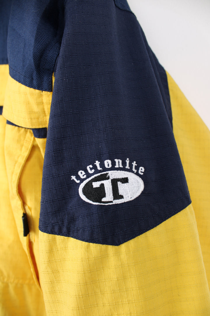 Columbia Tectonite Jacket in a yellow and navy blue colourway, zip up, multiple pockets, insulated lining, hooded and has the logo embroidered on the front.