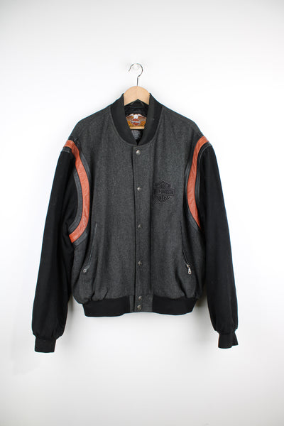 Vintage Harley Davidson varsity style wool bomber jacket. Features a grey wool body with black wool arms and leather trim around the arms. Has embroidered logo on the chest and back.   good condition  Size in Label:  Mens XL - Measures more like a XXL