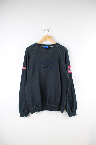 Vintage 90's faded black sweatshirt, features embroidered Umbro logo on the chest, back and badge on the sleeve