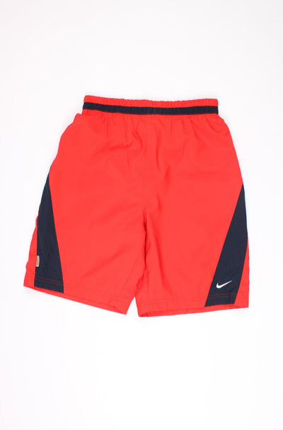 00's red Nike sports shorts with elasticated waist and embroidered swoosh logo on the leg 