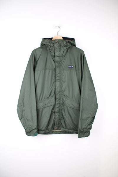 Patagonia Waterproof Jacket in a green colourway, zip up, hooded, adjustable cuffs and has the logo embroidered on the front.