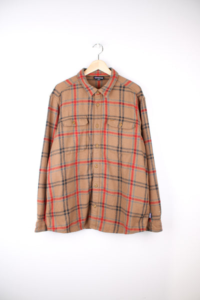 Patagonia Flannel Shirt in a brown, blue and red colourway, button up, chest pockets, and has the logo embroidered on the side.