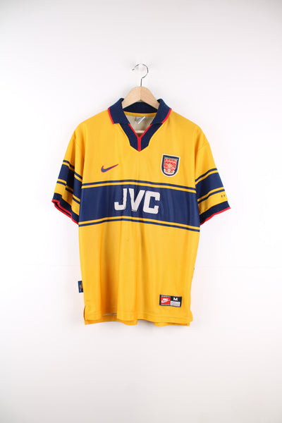 Arsenal 1997 - 1998 away football shirt in yellow and navy blue colour scheme.  good condition - some pulls to the fabric, JVC sponsorship is peeling off and has bobbling around the collar (see photos) Size in Label: Mens Size M 