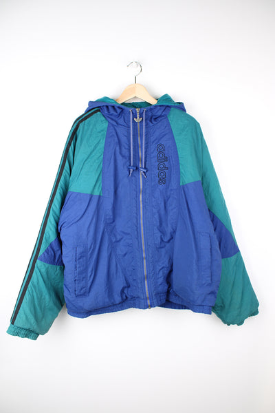 Vintage 90's blue and green Adidas bomber jacket, with embroidered logo on the chest and signature three stripes down the arms