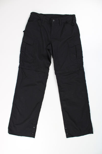 All black The North Face tech trousers with multiple pockets and elasticated waistband and zip off legs