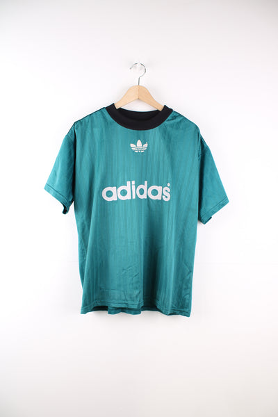 Vintage 90s Adidas training t-shirt in turquoise  with white flocked logos on the chest. fair condition - paint on the arm, cracking/ greying to the logos and some pulls in the fabric (see photos) Size in Label: Mens M