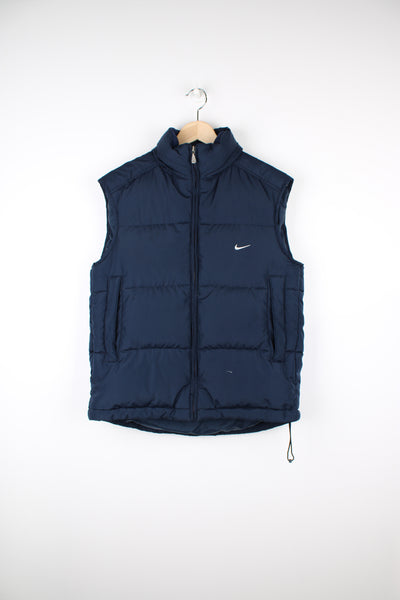 2000s navy blue Nike zip through puffer gilet, with swoosh embroidered logo on the front and foldaway hood