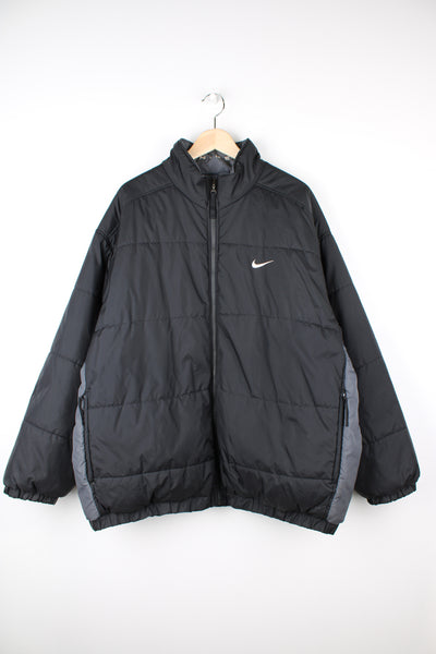 Vintage 2000's reversible Nike puffer jacket in black and grey, features embroidered logos on the chest