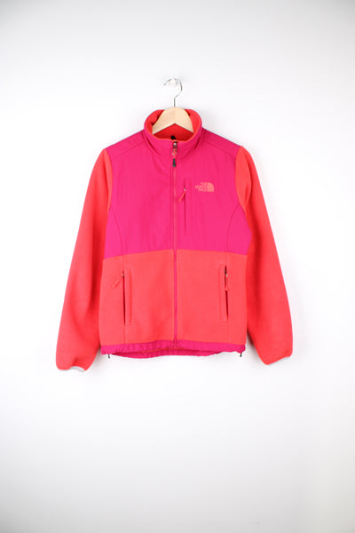 The North Face Denali Fleece in a orange and pink colourway, zip up, multiple pockets and has the logo embroidered on the front and back.
