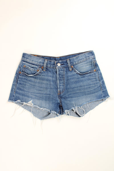 Vintage Levi's 501 blue denim cut off shorts with frayed edges