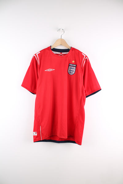 England 2004/05 Umbro Away Football Shirt in a red colourway, and has the logos embroidered on the front.