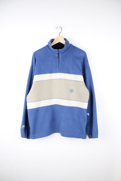 Helly Hansen Fleece in a blue and beige colourway, blocked colour stripe design, quarter zip and has the logo embroidered on the front and bottom of the right sleeve.