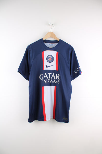 Paris Saint-Germain 2022/23 Nike Football Shirt in a blue, red and white colourway, Messi number 30 printed on the back, and has the logos embroidered on the front as well as 'goat' printed on the left sleeve.
