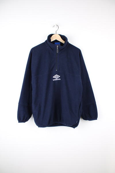 Umbro Pullover Fleece in a blue and white colourway, quarter zip, side pockets and has the logo embroidered on the front and back.