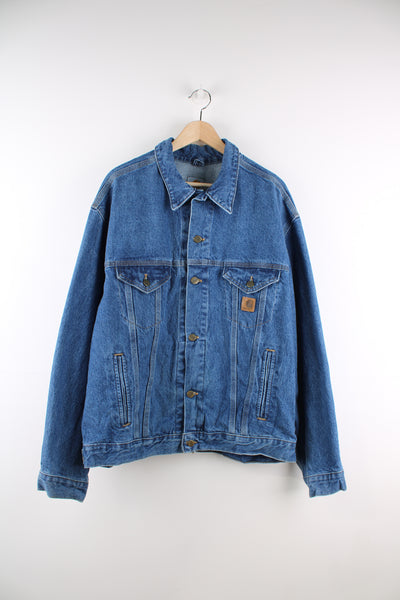 Carhartt Denim Jacket in a blue colourway, button up, multiple pockets, and has the logo embroidered on the front.