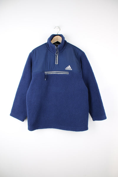 Adidas Fleece in a blue colourway, pullover, quarter zip, pouch pocket, 3m reflective lining on the zip and pocket, also has the logo embroidered on the front.