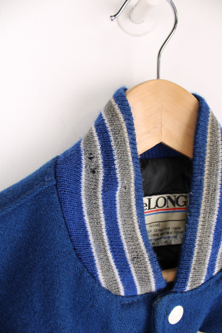 Vintage Delong, Fruita Monument Wildcats varsity jacket in blue with white leather sleeves. Features embroidered letterman patches and large spell out embroidery across the back.  