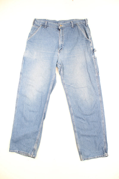 Carhartt blue denim carpenter jeans with multiple pockets and signature logo on the back pocket