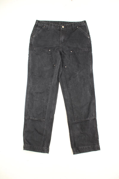 Carhartt all black double knee carpenter jeans with multiple pockets and signature logo on the back pocket 