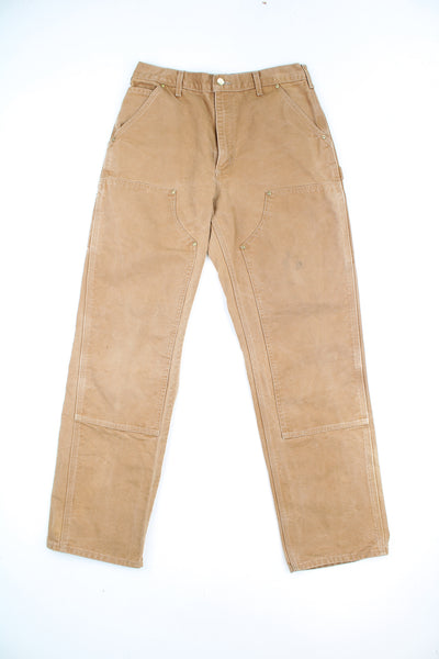 Carhartt double knee carpenter jeans in tan with multiple pockets and signature logo on the back pocket 
