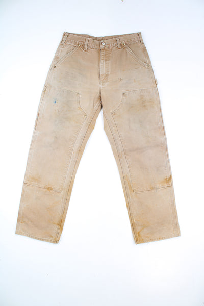 Carhartt double knee carpenter jeans in tan with multiple pockets and signature logo on the back pocket  