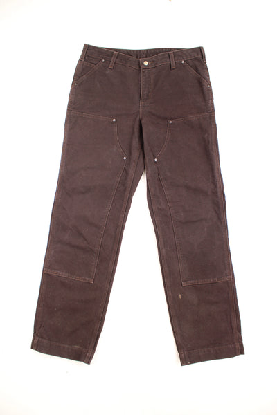 Carhartt double knee carpenter jeans in brown with multiple pockets and signature logo on the back pocket  