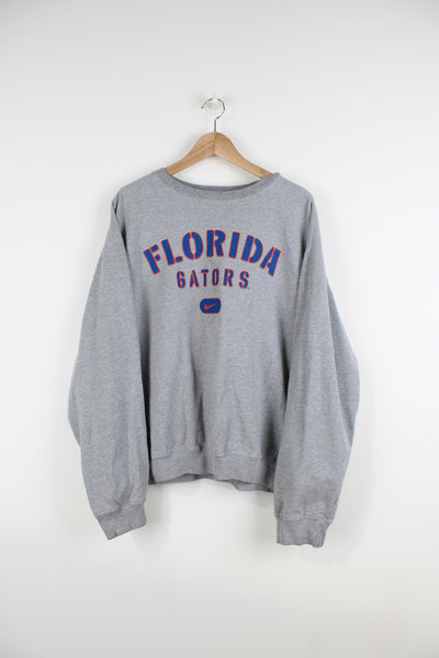 Vintage Florida Gators, grey crewneck sweatshirt by Nike. Features printed spell-out logo across the chest 