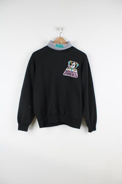 Vintage early 90's Anaheim Mighty Ducks black roll neck sweatshirt, made in the USA by Majestic. Features embroidered badge on the chest and spell-out logo on the neck.