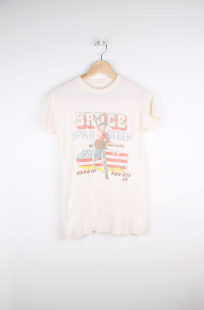 Vintage replica Bruce Springsteen Born in the USA 1985 tour t-shirt. Off white/ cream t-shirt with a slim/ baby tee style fit. good condition Size in Label:  No size - Measures like a womens XS
