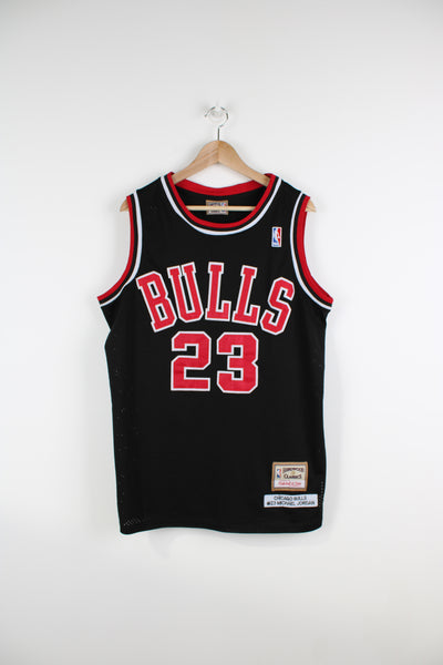 Vintage Chicago Bulls #23 Michael Jordan basketball jersey by Mitchell & Ness. Features embroidered spell-out details on the front and back